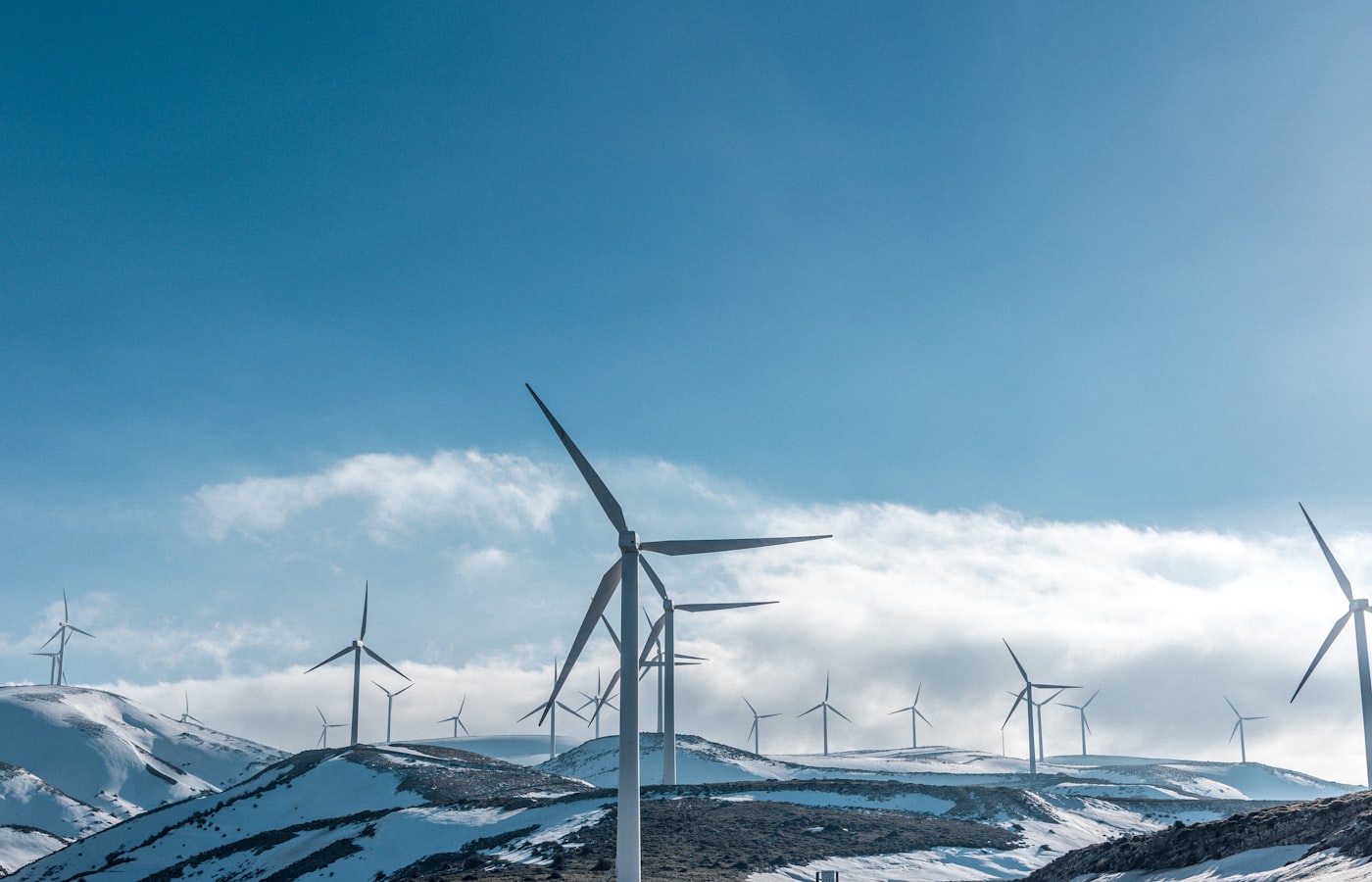 Sustainable technology - wind turbines representing our commitment to reducing e-waste through universal USB-C